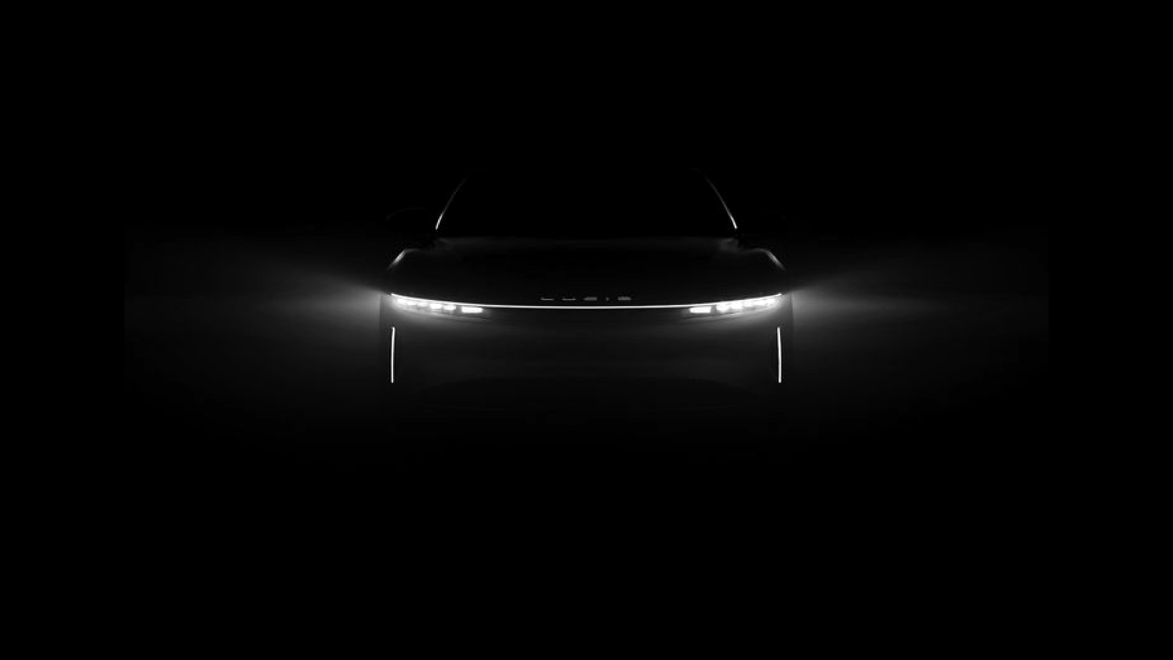 Lucid vehicle front lighting in a dark studio